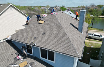 Getting started with stripping off old asphalt shingles on a roof in Providence Village, TX