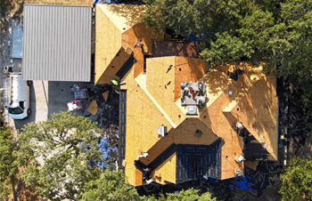 Finishing stripping off old shingles during a roof replacement in Cross Roads, TX.